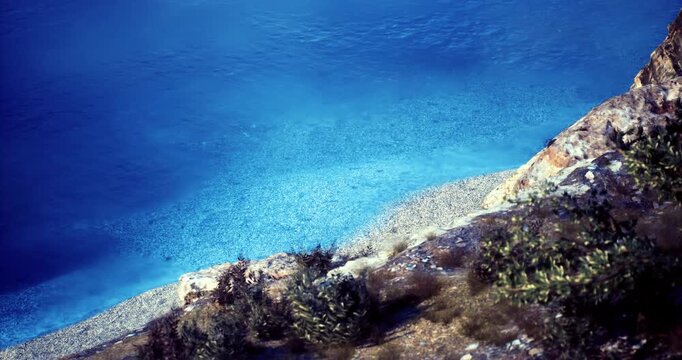 Clear turquoise waters gently lap against a pebbled beach surrounded by lush greenery. Sunlight dances on the water, creating a serene atmosphere perfect for relaxation.