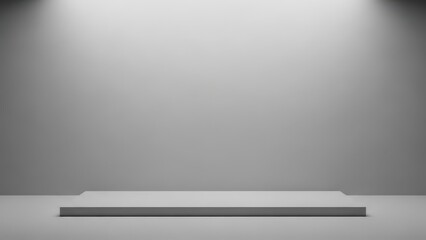 a large empty gray room with a spotlight shining down on a white platform in the center of the floor space