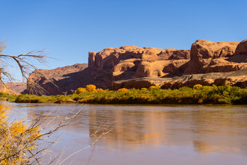 Majestic views along the Corona Arch trail in Moab, Utah, featuring towering Navajo sandstone formations, the massive freestanding arch, and the iconic ladder and cable sections under a deep blue sky.