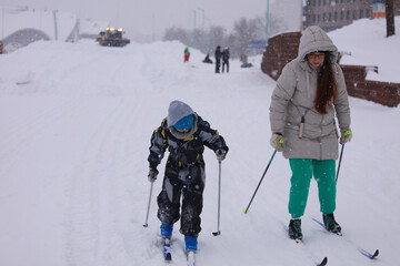 mom and son are skiing and having a good time	