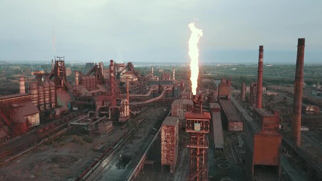 A drone flyover of a steel plant demonstrates the environmental impact and smoke from the chimneys.