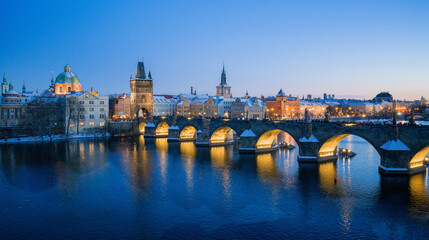 Obraz premium High Resolution Panorama Picture of Winter Snowy Prague Old Town with Prague Castle and Charles Bridge above River Vltava during Sunset , Czech republic