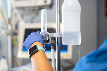 Nurse adjusting medical equipment for patient care