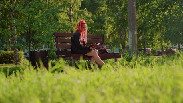 quiet lady immersed in scenic nature reading, relaxed woman explores literature in lush natural surroundings, calm female reader savoring tranquil moments amidst colorful outdoor scenery