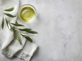 food background with linen napkin, olive branch and olive oil on concrete surface, top view