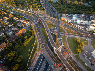 Aerial view of a complex highway interchange with traffic flowing during golden hour