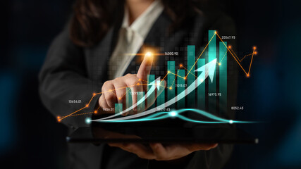 A businesswoman interacts with digital graphs showcasing financial growth and data analysis, emphasizing modern trends in finance and strategy. Scalp
