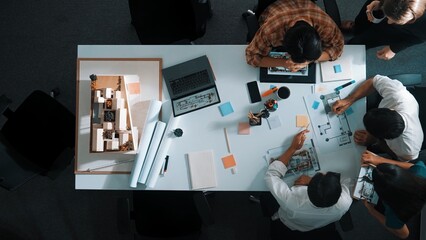 Top aerial view business people brainstorming about building interior at table with house model and...