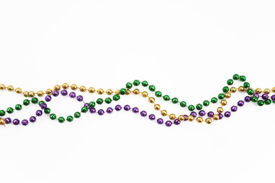 Mardi gras beads creating a colorful festive border