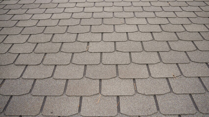 Gray asphalt roof shingles creating geometric pattern