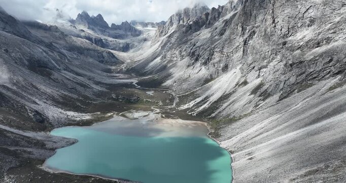 Aerial view of beautiful high altitude lake and snow capped mountain landscape