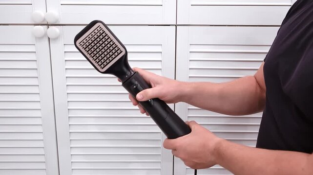 Hair dryer in male hands. Air brush for hair. High quality 4k footage.