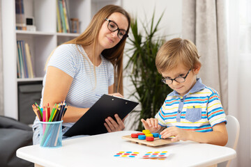 Child Engaged in Educational Activity with Teacher in Classroom Setting