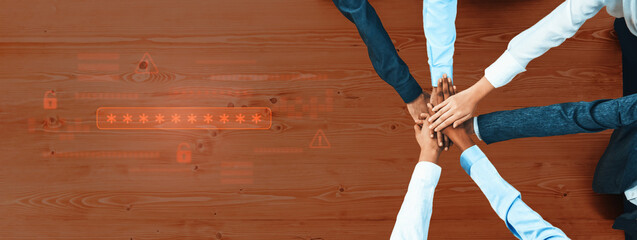 A group of diverse hands gathers in a circle on a wooden table, representing teamwork and collaboration in a professional setting focused on unity and success. Trope