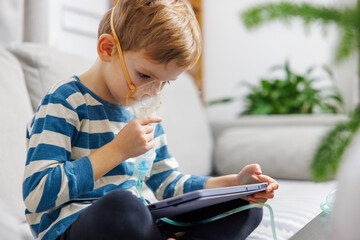 Child Using Nebulizer While Engaged with Tablet at Home