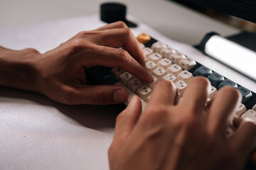 Close-up cropped shot of mechanical keyboard featuring vibrant keycaps, illuminating workspace during concentrated typing under soft ambient lighting. Concept of modern technology.