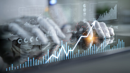 Hands typing on a transparent screen filled with graphs and data trends, showcasing modern digital analysis in a professional business environment. Scalp
