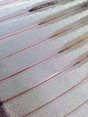 Beautiful white frost patterns on a glass surface during a freezing winter morning showing the intricate crystal structures created by nature in very cold weather temperatures now