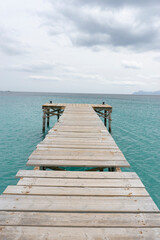 Fototapeta premium Wooden pier extending into turquoise water.. Palma de Mallorca, Spain