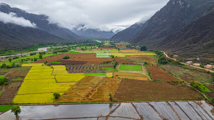 Aerial drone view of the valley and village of Mayasc&oacute;n surrounded by mountains in Lambayeque, Peru