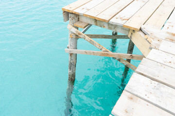 Wooden pier above clear turquoise water.. Palma de Mallorca, Spain
