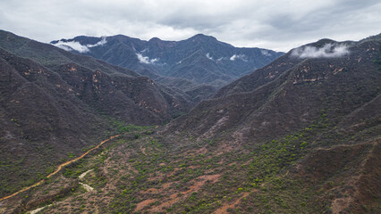 Panoramic aerial drone view of the mountains of Mayasc&oacute;n covered by clouds, Lambayeque, Peru