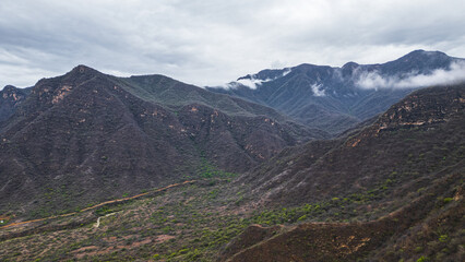 Panoramic aerial drone view of the mountains of Mayasc&oacute;n covered by clouds, Lambayeque, Peru