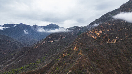 Panoramic aerial drone view of the mountains of Mayasc&oacute;n covered by clouds, Lambayeque, Peru