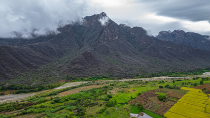 Aerial drone view of the valley and village of Mayasc&oacute;n surrounded by mountains in Lambayeque, Peru