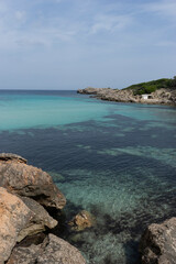 Naklejka premium Clear turquoise water near rocky coastline.. Palma de Mallorca, Spain
