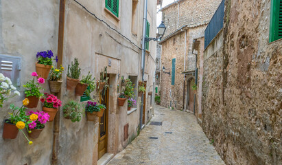 Travel Beautiful street in Valldemossa with traditional flower decoration, famous old mediterranean...