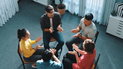 Top down view of smart business team working together and putting hands together. Aerial view of group of skilled business people brainstorming and making stack of hands at meeting room. Symposium.