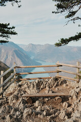 View from Banjska Stena viewpoint overlooking Drina River canyon and Perucac Lake in Tara National Park, Serbia. Rocky lookout with wooden fence above mountain landscape.