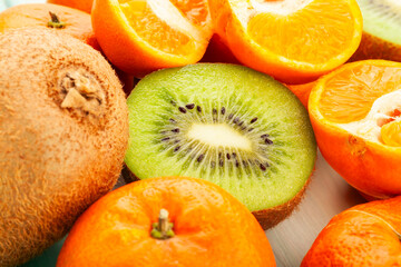 sliced kiwi tangerine on wood background