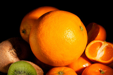orange tropical fruit mix on black background