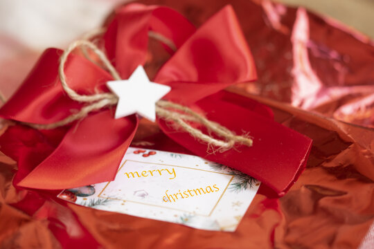 red christmas gift box with white star and merry christmas card