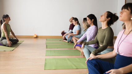Diverse group of women practicing prenatal yoga meditation