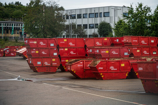 Gothenburg, Sweden - August 02 2025: Red metal dumpsters stacked at recycling facility.