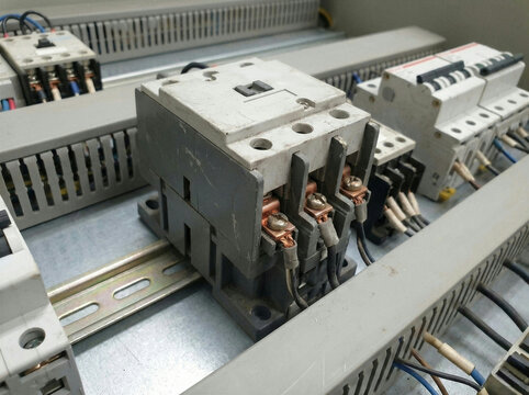 Magnetic contactor mounted on DIN rail in industrial electrical control panel