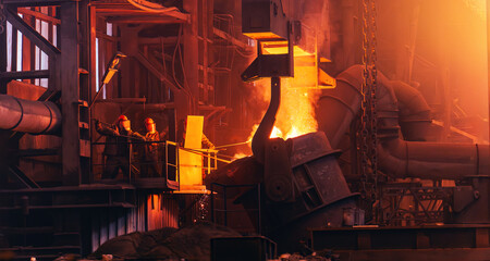 Steel foundry workers operating molten metal furnace in industrial plant with extreme heat, glowing sparks and heavy equipment in metallurgical production process.