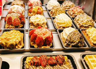 Filled Belgian waffles on display in a shop window.
