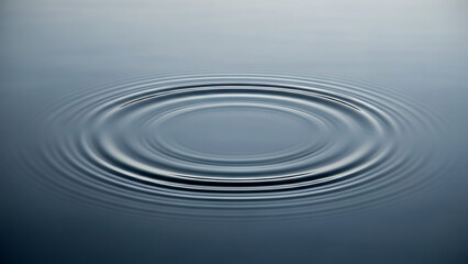 Calm blue water surface with concentric ripples originating from a single point, creating a serene and tranquil abstract background