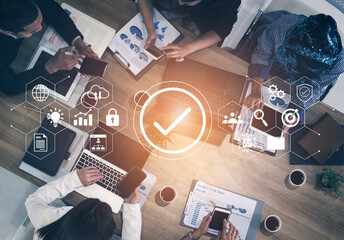 A business meeting scene featuring professionals collaborating over project data. They utilize technology and visual aids to enhance decision-making and foster teamwork. Gantry