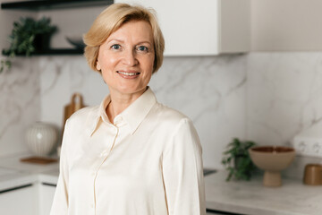 Happy woman enjoying her time at home in a cozy kitchen setting