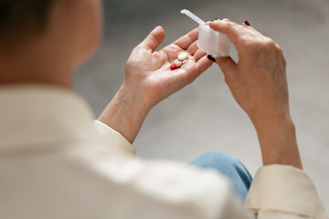 Senior person takes prescribed medication for mental health care at home