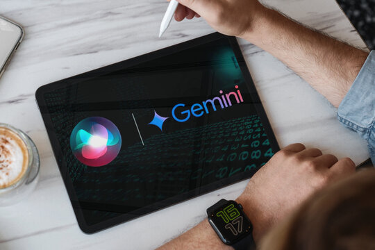 Person using tablet displaying gemini and siri ai logos