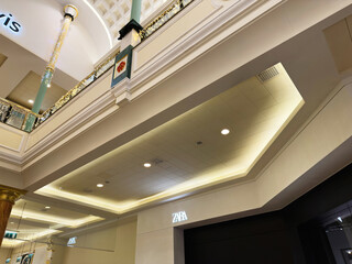 Naklejka premium Interior of a stylish mall in Manchester featuring Zara storefront and decorative lighting