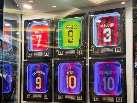Memorabilia shop window display of iconic soccer jerseys in Manchester UK