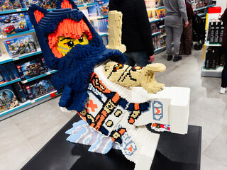 Naklejka premium Lego Ninjago sculpture on display in a Manchester toy store with shoppers
