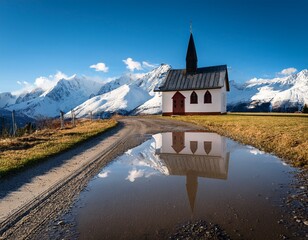 small chapel with snowy mountain reflection in a puddle on dirt road